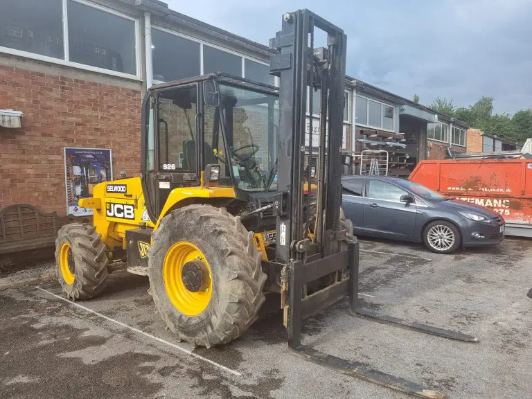 J1 rough terrain forklift carrying a load across an outdoor site